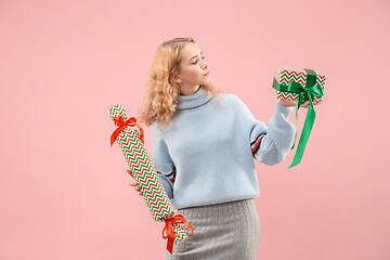 Image showing Woman with big beautiful smile holding colorful gift boxes.