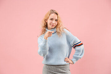 Image showing The happy business woman point you and want you, half length closeup portrait on pink background.