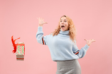 Image showing Woman with big beautiful smile holding colorful gift box.