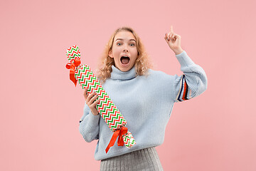 Image showing Woman with big beautiful smile holding colorful gift box.