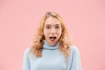 Image showing Beautiful woman looking suprised isolated on pink