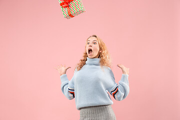 Image showing Woman with big beautiful smile holding colorful gift box.