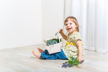 Image showing Cute girl with spring flowers