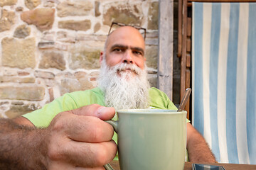 Image showing bearded man hands on coffee mug