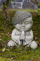 Image showing Jizo stone statue wearing knitted and cloth hats.