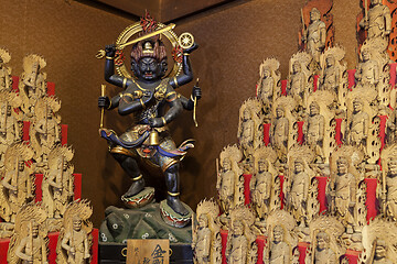 Image showing Little wooden statues in ancient japanese shrine