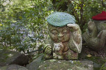 Image showing Monkey - symbol of japanese horoscope. Jizo stone statue wearing knitted and cloth hats.