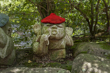 Image showing Rooster - symbol of japanese horoscope. Jizo stone statue wearing knitted and cloth hats.