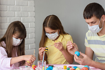 Image showing Ill children and dad paint Easter eggs for Easter