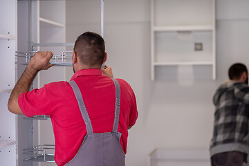 Image showing workers installing a new kitchen