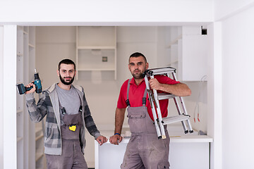 Image showing young workers installing a new kitchen