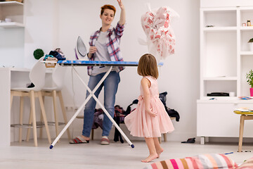 Image showing mother and little daughter spending time together at home