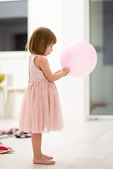 Image showing cute little girl playing with balloons