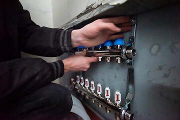 Image showing engineer checking technical data of heating system