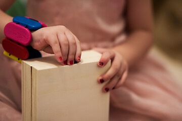 Image showing little girl enjoying while playing with mother\'s jewelry