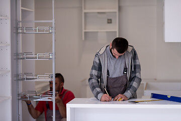 Image showing workers installing a new kitchen