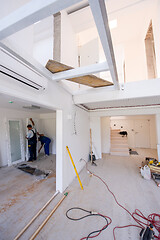 Image showing carpenters installing glass door with a wooden frame