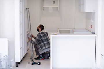 Image showing worker installing a new kitchen