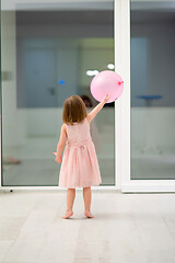 Image showing cute little girl playing with balloons