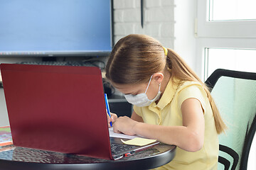 Image showing The girl performs the teacher\'s assignment received online