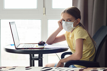 Image showing The girl is tired and is remotely studying in quarantine