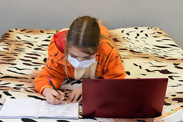 Image showing Quarantined medical mask girl self-study