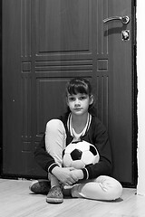 Image showing Girl locked up with a ball at the front door