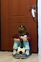 Image showing Girl in quarantine period is tortured sitting with a ball at the front door