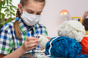 Image showing A sick girl in self-isolation is engaged in embroidery