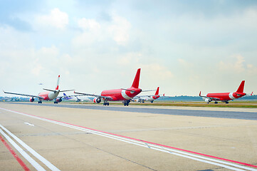 Image showing Airport runway full of planes