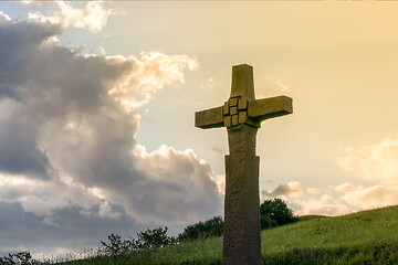 Image showing a stone cross in front of a dramatic evening sky