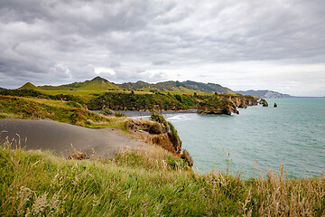 Image showing sea shore rocks and mount Taranaki, New Zealand