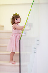 Image showing little girl playing on stairs at home