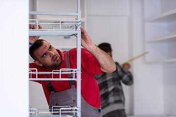 Image showing workers installing a new kitchen