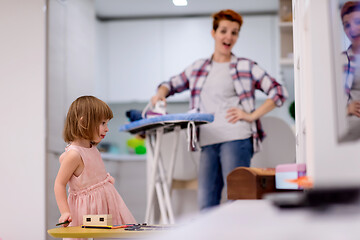 Image showing mother and little daughter spending time together at home