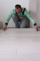 Image showing worker installing the ceramic wood effect tiles on the floor