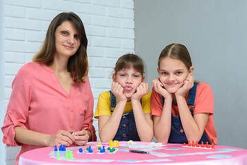 Image showing Young family plays board games and looked into the frame