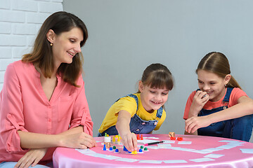 Image showing Girl makes another move playing a board game