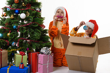 Image showing Two girls fooling around and looking at Christmas toys