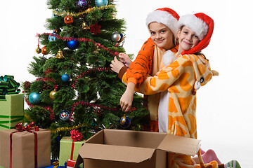 Image showing Two girls funny take off toys from a New Year tree