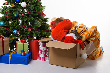 Image showing Two girls crawled headlong into a box with New Year\'s toys