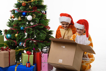Image showing Two girls look in a box with New Year\'s toys