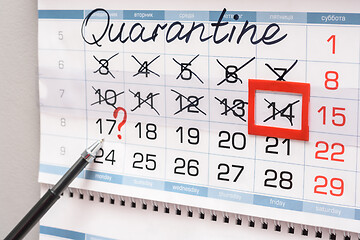 Image showing The pen indicates Monday on the calendar with a question mark, previous weeks are crossed out due to quarantine