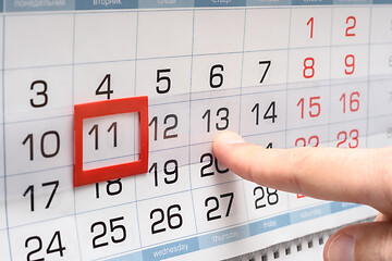 Image showing The finger points to the future Thursday on the calendar