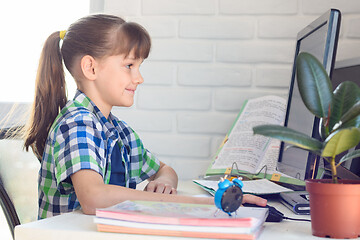 Image showing The girl is studying remotely at home, using online learning