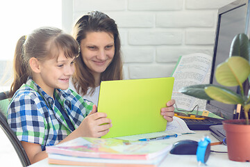 Image showing Mom and daughter communicate via video using a tablet computer