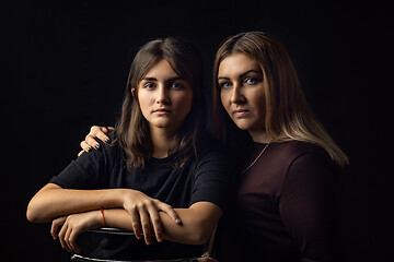 Image showing Black and white portrait of mother and daughter on a black background