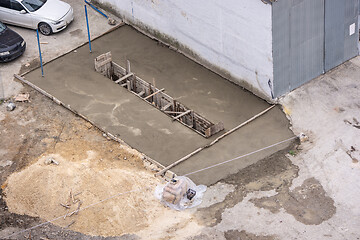 Image showing Inspection pit freshly concrete and fenced with formwork for machine repair