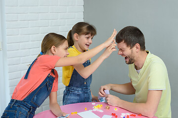 Image showing Children beat dad scribble for losing the game