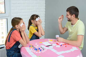 Image showing Dad and daughters play board games at home